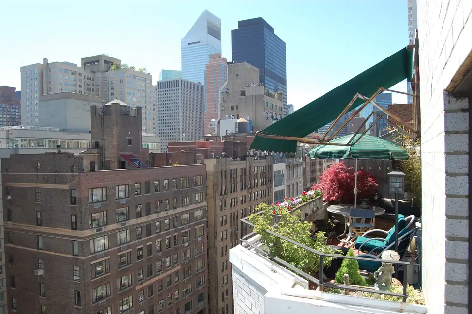 Planted terrace high on a Manhattan apartment building with containers along the parapet